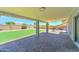 Covered patio with brick pavers and artificial grass is ideal for outdoor living and entertaining at 1716 W Villa Theresa Dr, Phoenix, AZ 85023