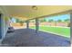Covered patio with a large backyard featuring artificial grass at 1716 W Villa Theresa Dr, Phoenix, AZ 85023