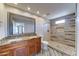 Beautiful bathroom with dual sinks, stone countertops, and a stunning tiled walk-in shower at 1716 W Villa Theresa Dr, Phoenix, AZ 85023