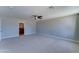 Large primary bedroom with plush carpet, ceiling fan, and adjacent ensuite bathroom at 1716 W Villa Theresa Dr, Phoenix, AZ 85023