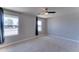 Inviting bedroom with carpet, neutral walls, a ceiling fan, and natural light from dual windows at 1716 W Villa Theresa Dr, Phoenix, AZ 85023
