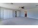 Spacious bedroom with carpet, ceiling fan, walk-in closet, and ensuite bathroom access at 1716 W Villa Theresa Dr, Phoenix, AZ 85023