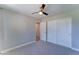 A cozy bedroom with neutral walls and carpet, ceiling fan and large closet at 1716 W Villa Theresa Dr, Phoenix, AZ 85023