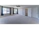 Large bedroom featuring plush carpeting, ceiling fan, and double door closet at 1716 W Villa Theresa Dr, Phoenix, AZ 85023