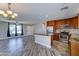 Open concept kitchen featuring stainless steel appliances, granite countertops, and wood look tile flooring at 1716 W Villa Theresa Dr, Phoenix, AZ 85023