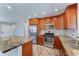 Modern kitchen featuring stainless steel appliances, granite countertops, and a tile backsplash at 1716 W Villa Theresa Dr, Phoenix, AZ 85023