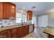 Granite countertops and stainless steel appliances accent this kitchen featuring wood look tile flooring and brick backsplash at 1716 W Villa Theresa Dr, Phoenix, AZ 85023