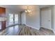 Open dining area with french doors and modern lighting adjacent to updated kitchen at 1716 W Villa Theresa Dr, Phoenix, AZ 85023