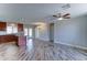 Spacious open-concept living area featuring kitchen, dining, and living spaces with wood look tile floors at 1716 W Villa Theresa Dr, Phoenix, AZ 85023