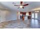 Open-concept living area with wood look tile floors connecting the kitchen to the living space at 1716 W Villa Theresa Dr, Phoenix, AZ 85023