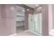 Spa-like bathroom featuring a glass enclosed shower, neutral paint and a spacious walk-in closet at 17352 W Red Fox Rd, Surprise, AZ 85387