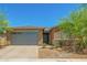 Charming single-story home featuring a two-car garage and drought-resistant landscaping at 17352 W Red Fox Rd, Surprise, AZ 85387