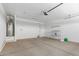 Spacious garage featuring ample storage potential and an overhead door for easy access at 17352 W Red Fox Rd, Surprise, AZ 85387