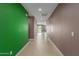Bright and long hallway with sleek tiled floors and neutral color palette at 17352 W Red Fox Rd, Surprise, AZ 85387