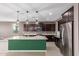 Modern kitchen featuring dark cabinetry, granite counters, and stainless steel refrigerator at 17352 W Red Fox Rd, Surprise, AZ 85387