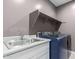 This laundry room boasts modern machines, a utility sink, and storage shelving for convenience at 17352 W Red Fox Rd, Surprise, AZ 85387