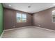 Neutral-painted living room with recessed lighting, window, and tile floors, providing a serene and inviting space at 17352 W Red Fox Rd, Surprise, AZ 85387