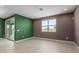 Spacious living room features wood-look tile, neutral paint, recessed lighting and a large window at 17352 W Red Fox Rd, Surprise, AZ 85387