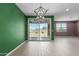 Inviting living room featuring tile floors, recessed lighting, backyard access and a modern chandelier at 17352 W Red Fox Rd, Surprise, AZ 85387