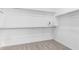 Walk-in closet featuring ample storage space with built-in shelving, rod and neutral carpet flooring at 17352 W Red Fox Rd, Surprise, AZ 85387