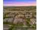 Aerial view showcasing a well-designed neighborhood with lush greenery, pools and mountain backdrop at 17850 E Bronco Ct, Queen Creek, AZ 85142