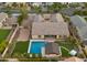 Stunning aerial view of backyard oasis with pool, cabana, spa, and lush landscaping in a well-manicured neighborhood at 17850 E Bronco Ct, Queen Creek, AZ 85142