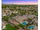 This aerial shot captures a home with a beautiful pool, spa, and lush green backyard, perfect for entertaining at 17850 E Bronco Ct, Queen Creek, AZ 85142