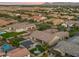 An aerial view of a neighborhood with a swimming pool and mountain views, perfect for enjoying the outdoors at 17850 E Bronco Ct, Queen Creek, AZ 85142