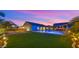 Relaxing backyard featuring a sparkling pool, covered patio and lush turf at 17850 E Bronco Ct, Queen Creek, AZ 85142