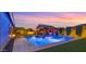 Stunning backyard with a pool, covered outdoor kitchen and inviting seating area at 17850 E Bronco Ct, Queen Creek, AZ 85142