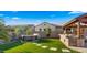 Luxurious backyard featuring a hot tub, outdoor kitchen, and manicured artificial grass for year-round enjoyment at 17850 E Bronco Ct, Queen Creek, AZ 85142