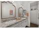 Bathroom featuring dual sinks, granite countertops, and decorative mirrors at 17850 E Bronco Ct, Queen Creek, AZ 85142