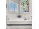 Elegant soaking tub in bathroom featuring tile accents and natural light, a perfect space for relaxation at 17850 E Bronco Ct, Queen Creek, AZ 85142