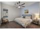 Cozy bedroom featuring a ceiling fan, a window, and neutral décor at 17850 E Bronco Ct, Queen Creek, AZ 85142