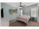 Bedroom with a ceiling fan, light blue walls, and natural light at 17850 E Bronco Ct, Queen Creek, AZ 85142