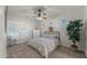 Cozy bedroom with ceiling fan, window shutters, and neutral decor at 17850 E Bronco Ct, Queen Creek, AZ 85142