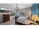 Bright bedroom features a blue accent wall, wood furniture, and large windows for plenty of light at 17850 E Bronco Ct, Queen Creek, AZ 85142