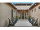 Charming courtyard featuring Adirondack chairs, string lights, and potted plants leading to the front door at 17850 E Bronco Ct, Queen Creek, AZ 85142