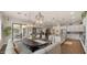 Open-concept dining room and kitchen features an island, stainless appliances, and bright lighting at 17850 E Bronco Ct, Queen Creek, AZ 85142