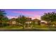 Inviting single-story home with lush green lawn and mature landscaping at 17850 E Bronco Ct, Queen Creek, AZ 85142