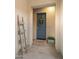 Entryway with blue front door, welcome mat, decor ladder, and planters at 17850 E Bronco Ct, Queen Creek, AZ 85142