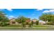 Attractive home exterior with a manicured lawn, mature trees, and a welcoming facade at 17850 E Bronco Ct, Queen Creek, AZ 85142