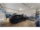 Organized three car garage featuring epoxy floors, cabinets, and ample storage for vehicles and tools at 17850 E Bronco Ct, Queen Creek, AZ 85142