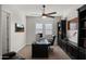Modern home office featuring a ceiling fan, built-in cabinets, and natural light at 17850 E Bronco Ct, Queen Creek, AZ 85142
