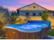 Relaxing hot tub with water feature and verdant landscaping at 17850 E Bronco Ct, Queen Creek, AZ 85142