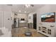 Kitchen featuring stainless steel refrigerator, neutral cabinets, and adjacent living area at 17850 E Bronco Ct, Queen Creek, AZ 85142