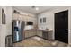 Bright kitchen with stainless steel refrigerator, neutral cabinets, and subway tile backsplash at 17850 E Bronco Ct, Queen Creek, AZ 85142