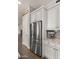 Close-up of a stainless steel refrigerator and white cabinets with contrasting hardware at 17850 E Bronco Ct, Queen Creek, AZ 85142