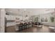 Well-lit kitchen with white cabinets, granite countertops, stainless steel appliances, and a breakfast bar at 17850 E Bronco Ct, Queen Creek, AZ 85142