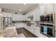 Modern kitchen showcasing stainless steel appliances, granite countertops, and ample cabinet space at 17850 E Bronco Ct, Queen Creek, AZ 85142